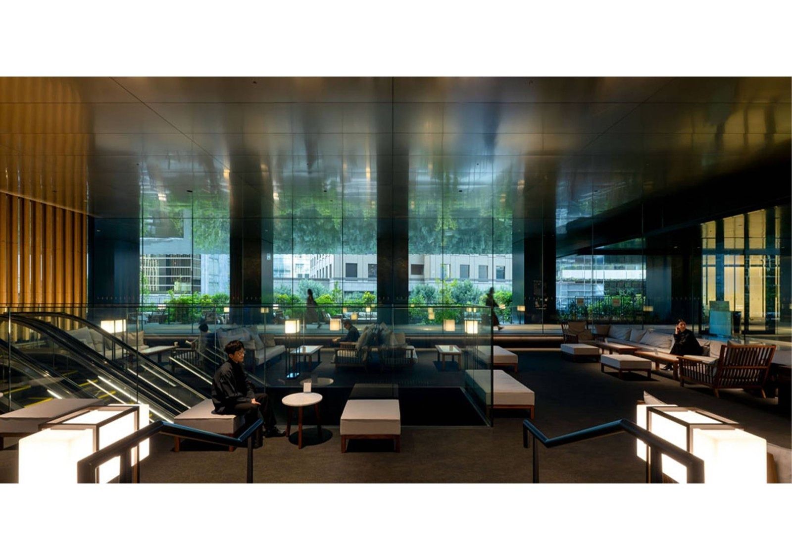 Honda: Atrium with escalator and lounge seating by tall windows