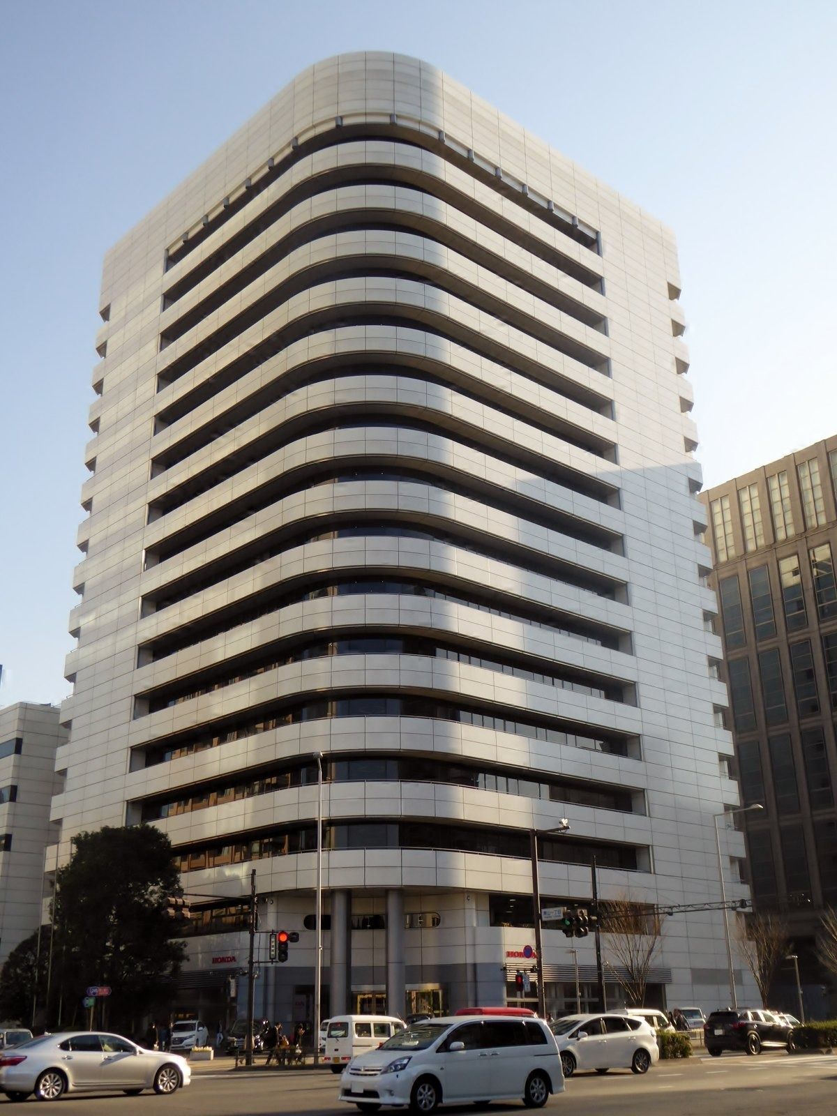 White office building with curved horizontal bands