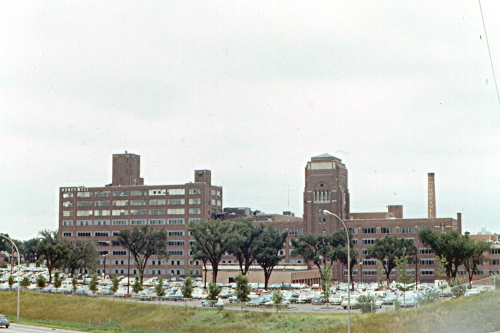 Large brick headquarters behind a field
