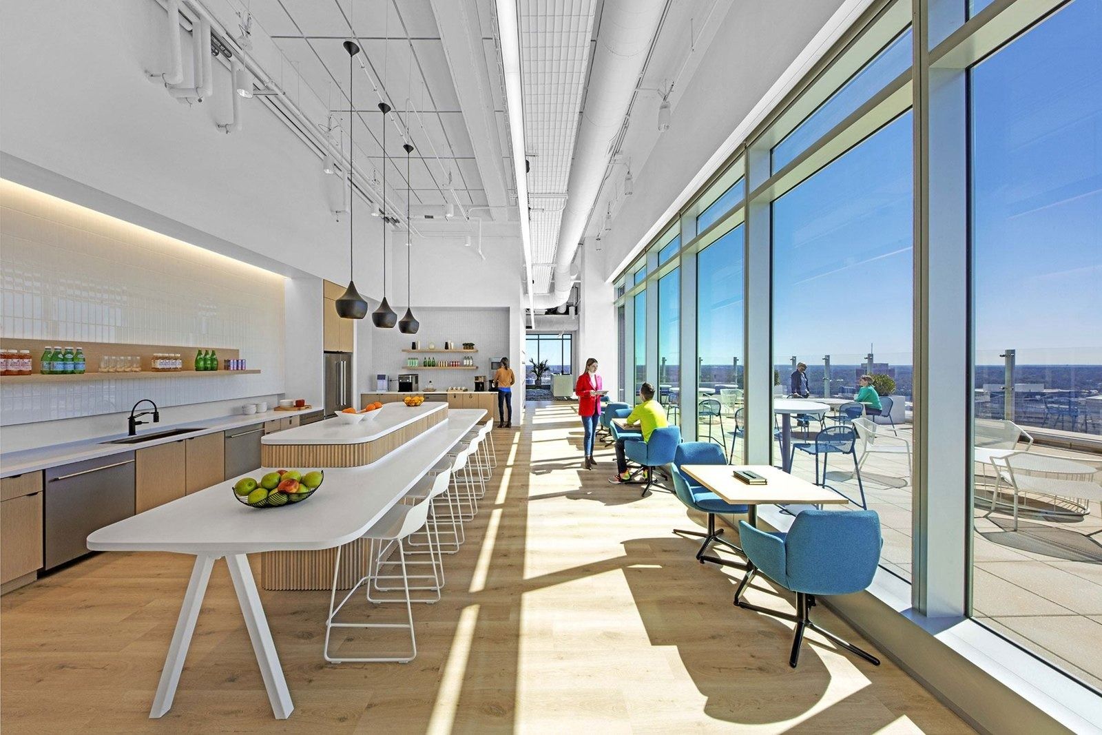 Honeywell: Long café table by tall windows overlooking the city