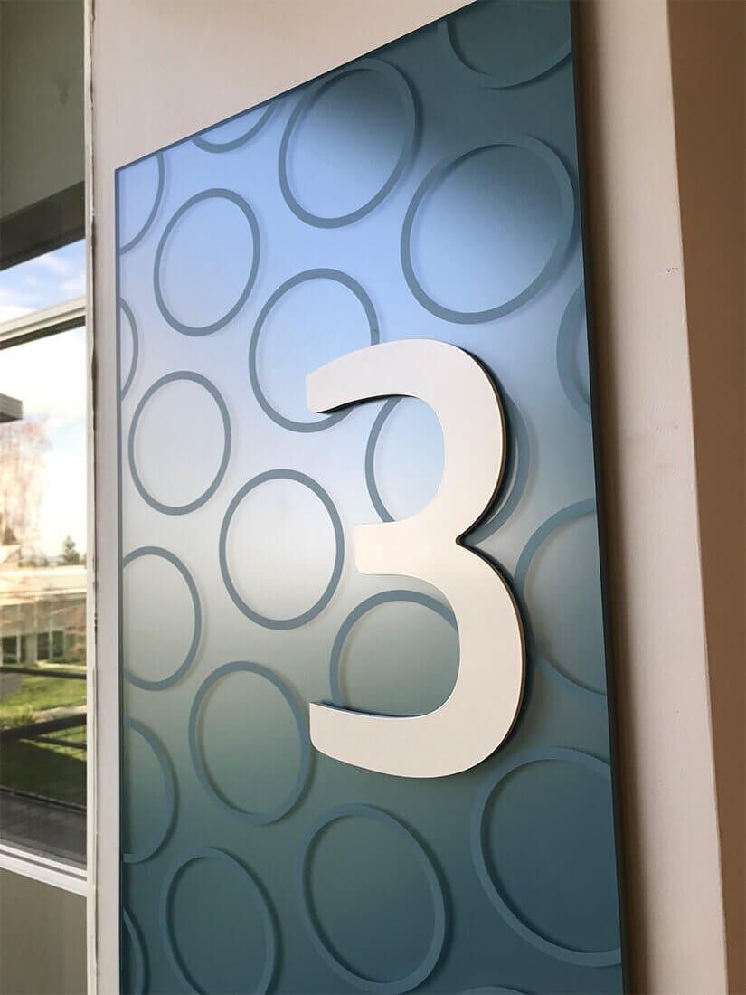 HP Inc.: A big number 3 sign on a patterned panel