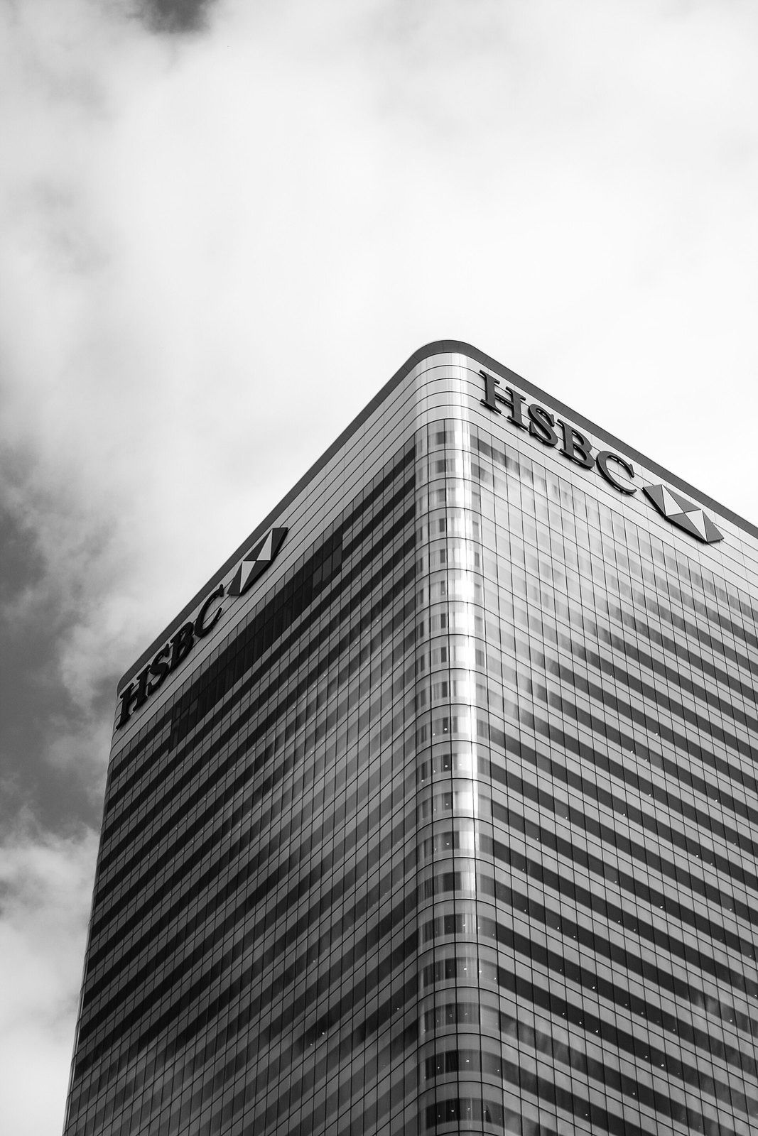 HSBC: Black and white view of a tower corner with logos near the roof