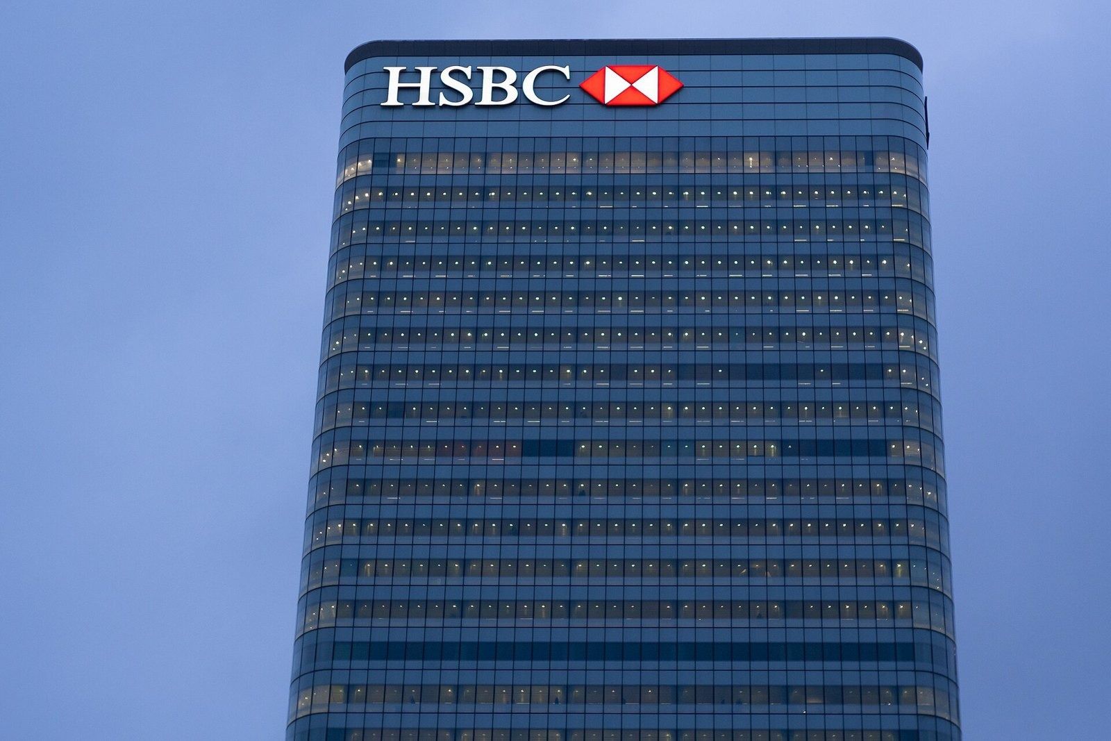 HSBC: Front of a blue-glass office tower with a bank logo at the top