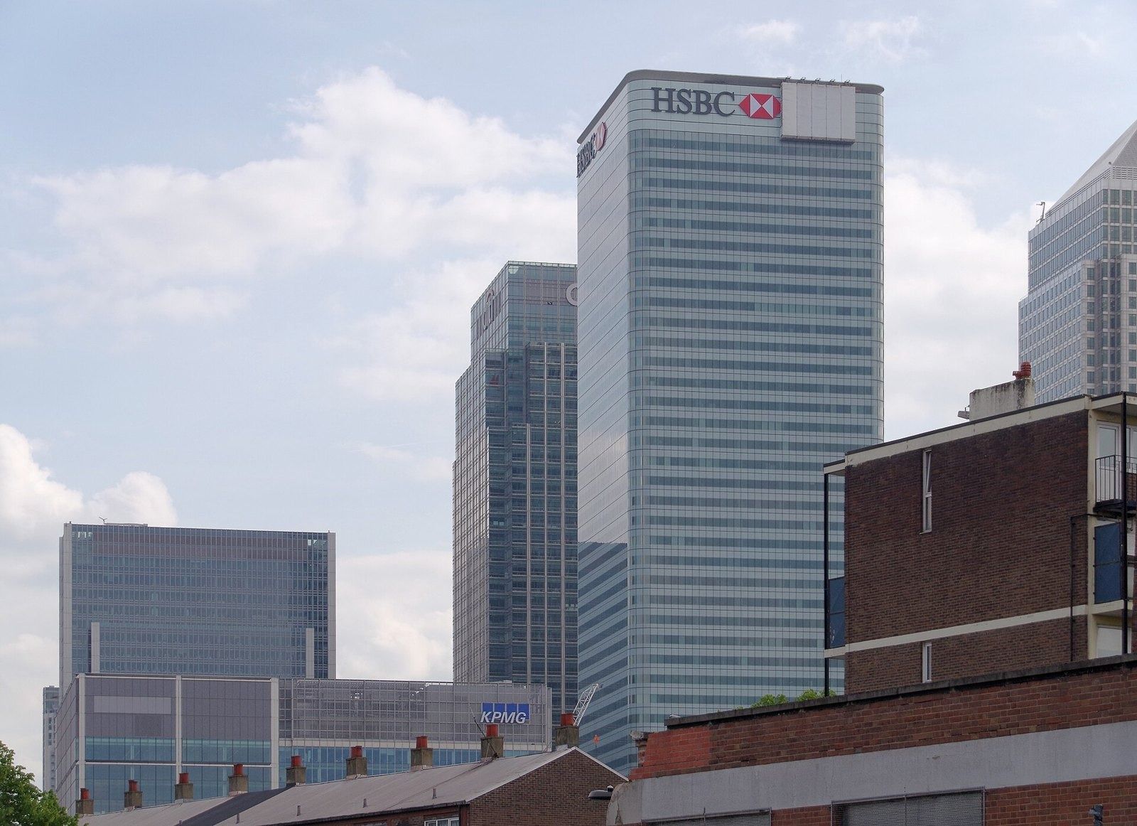 HSBC: Square glass tower with a bank logo rising above low brick buildings