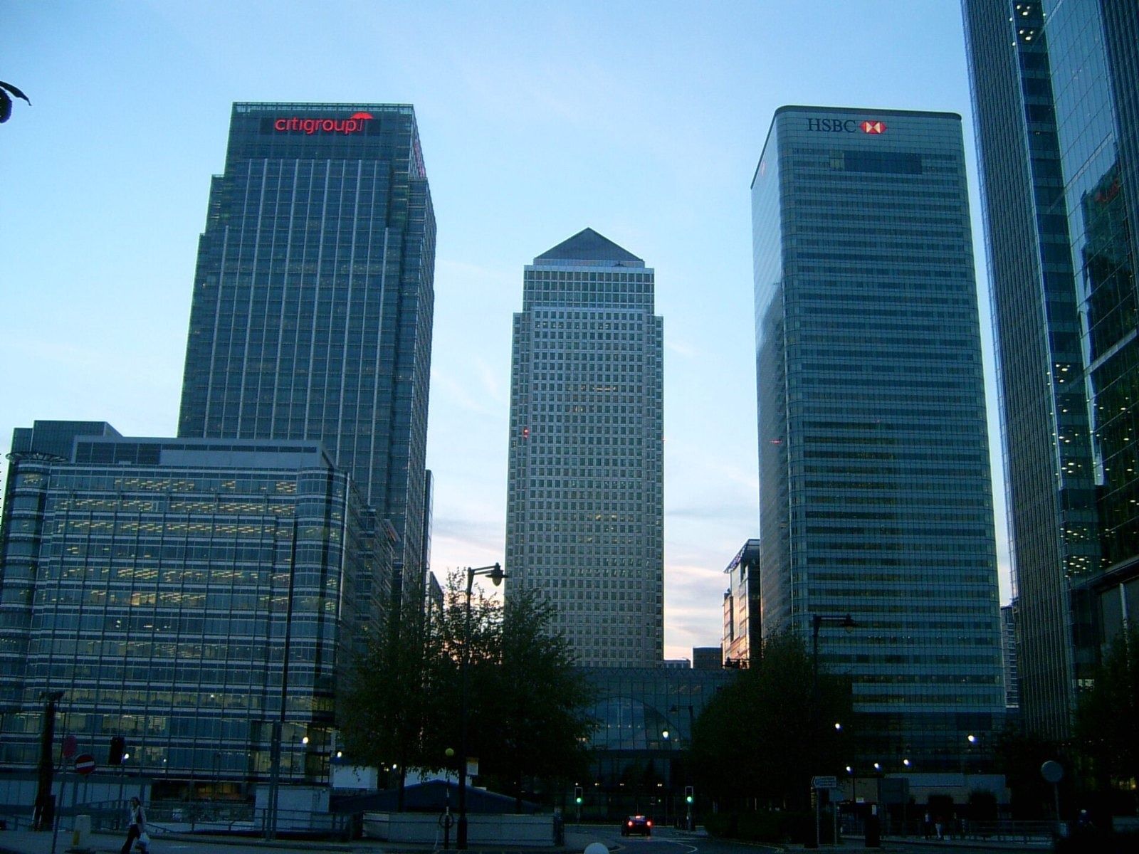 HSBC: Three tall office towers at dusk with trees in front