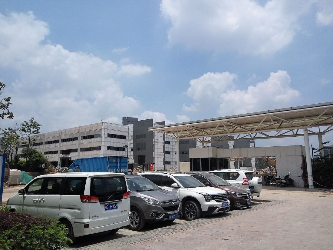 Huawei: Office buildings and a covered entrance beyond a car park