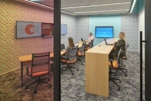 HubSpot: A glass meeting room with a tall table