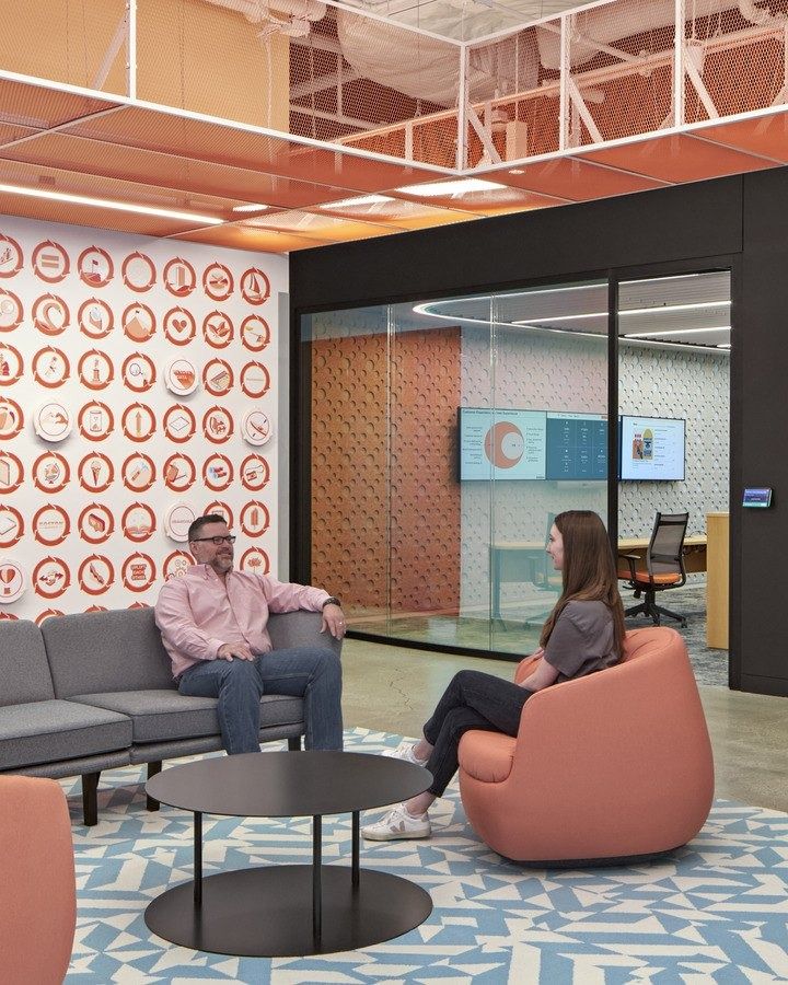 HubSpot: A lounge with orange armchairs and a target-pattern wall