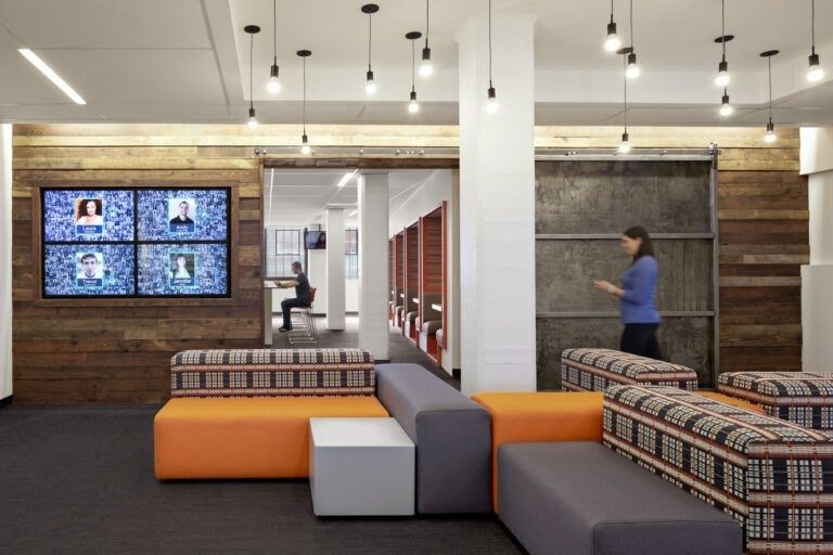 HubSpot: A lounge with patterned sofas and video screens