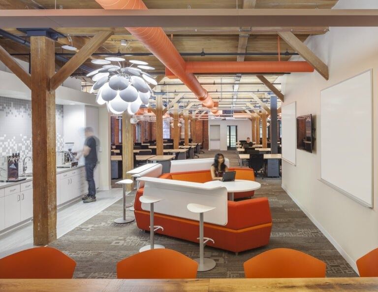 HubSpot: A white bar counter under a petal pendant light and timber beams