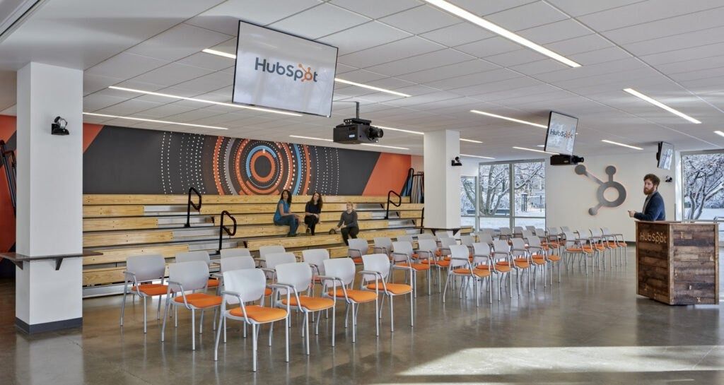 HubSpot: An auditorium with stepped seating and orange chairs