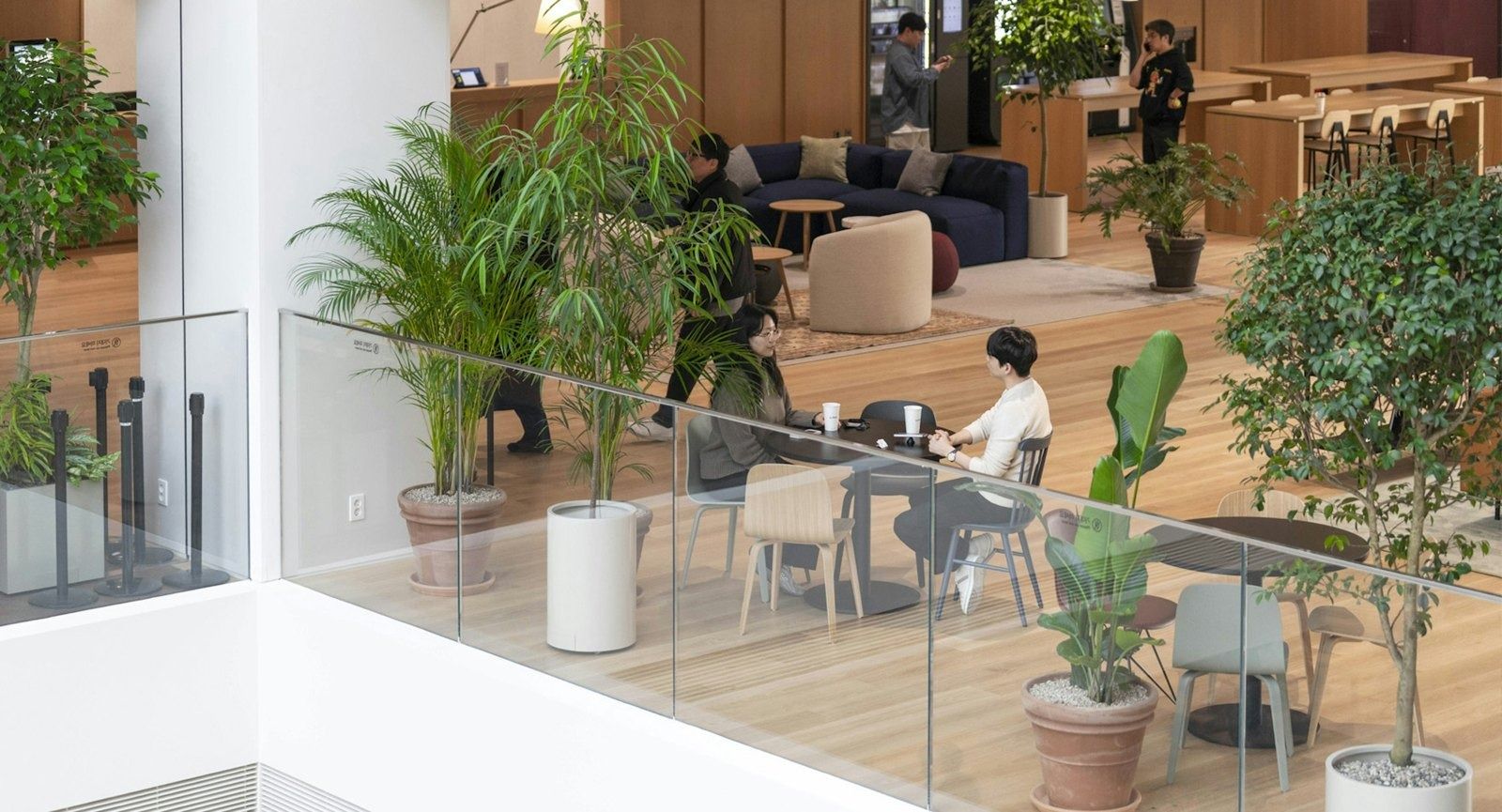 Hyundai Motor Company: Balcony seating among plants above the atrium