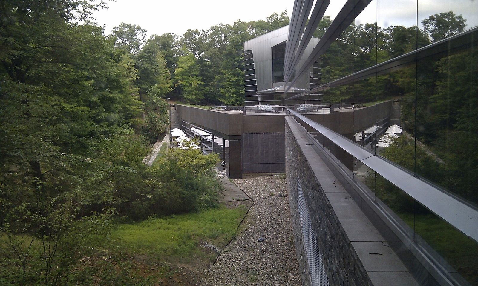 IBM: A walkway along the stainless-steel headquarters among trees