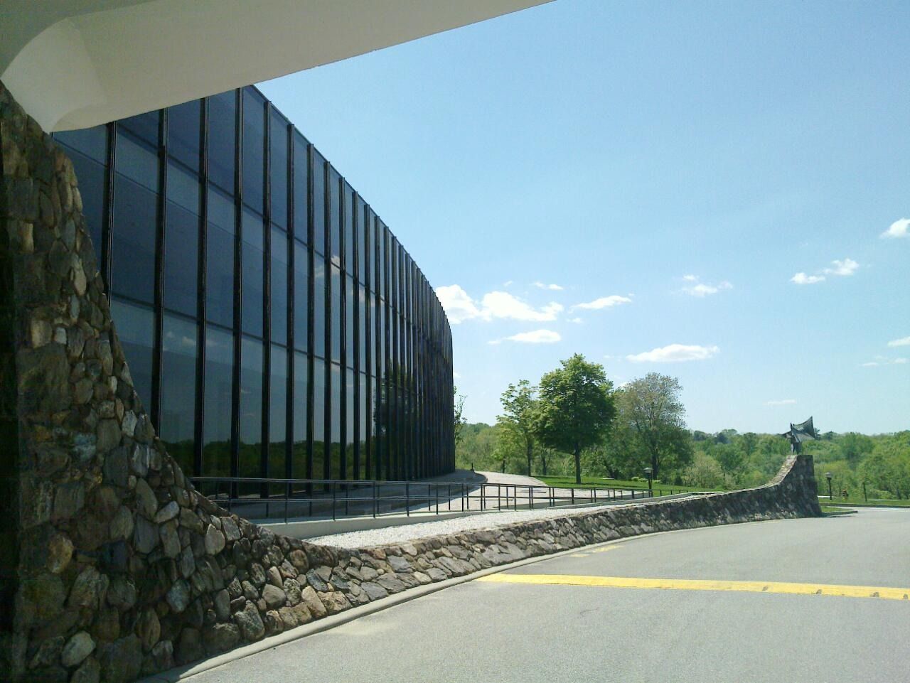IBM: The curved glass wall beside a stone wall
