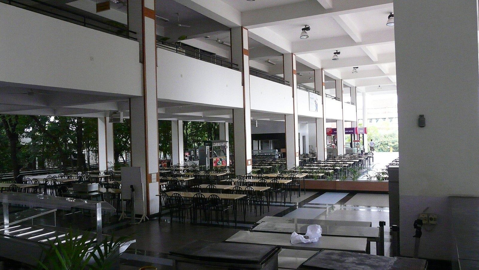 Infosys: Large open dining hall with rows of tables and a mezzanine