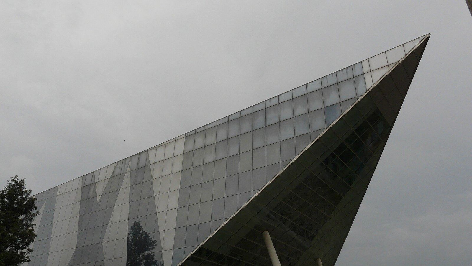 Infosys: Sharp glass corner of a building against a grey sky