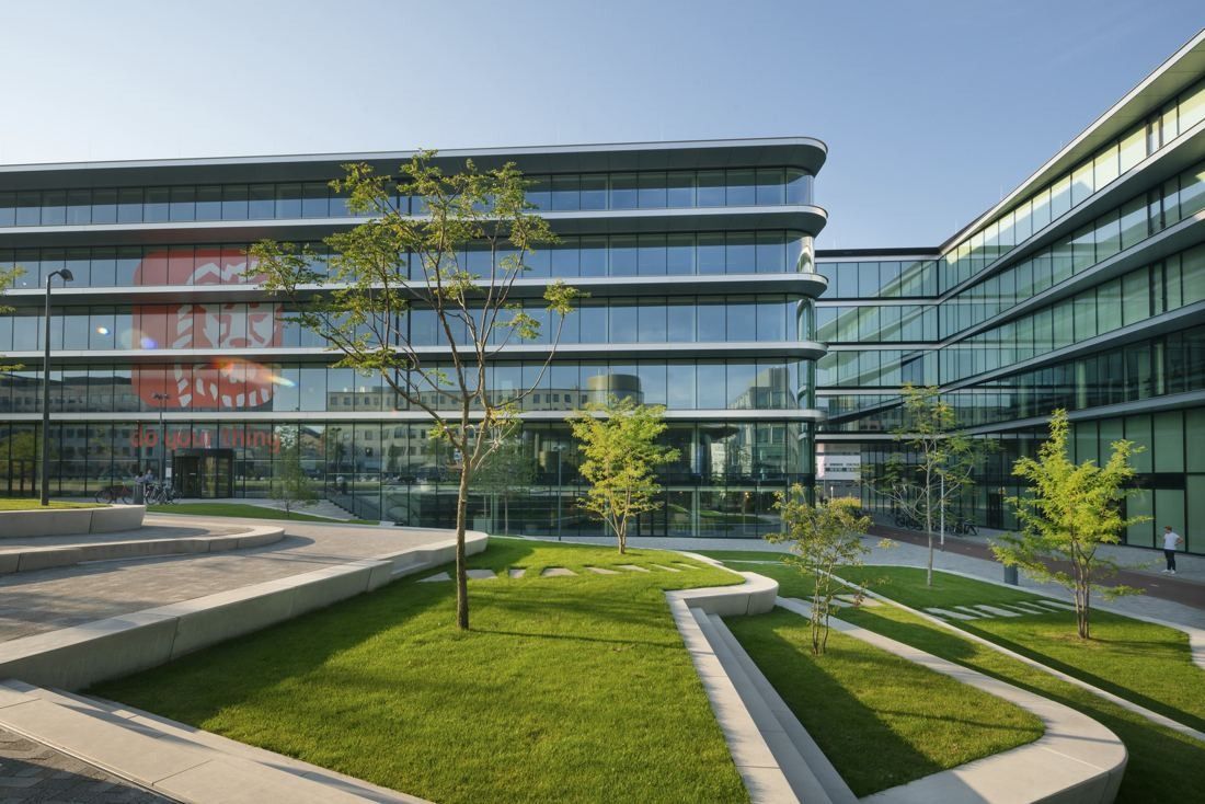 ING Group: Grassy courtyard with sloping planted beds between glass office wings