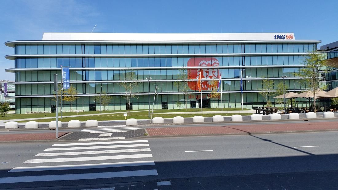 ING Group: Long glass façade with the ING logo on top, seen across a pedestrian crossing