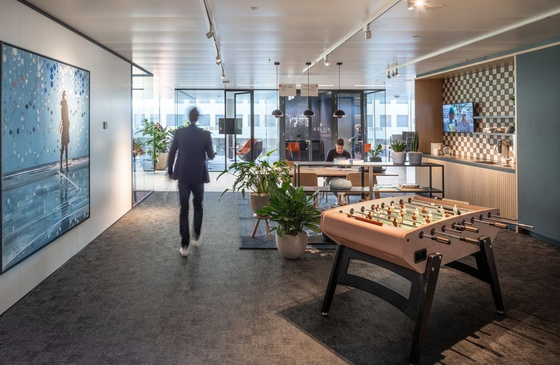 ING Group: Office floor with a foosball table, large painting and a person walking away from the camera