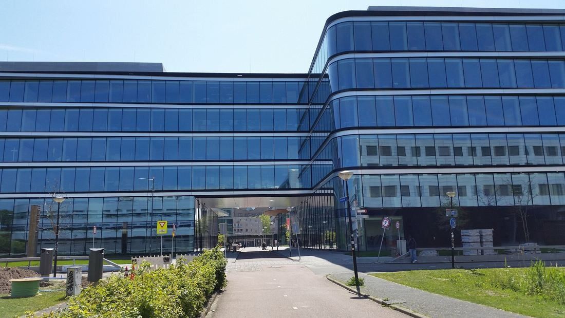 ING Group: Two glass office volumes joined above a driveway entrance