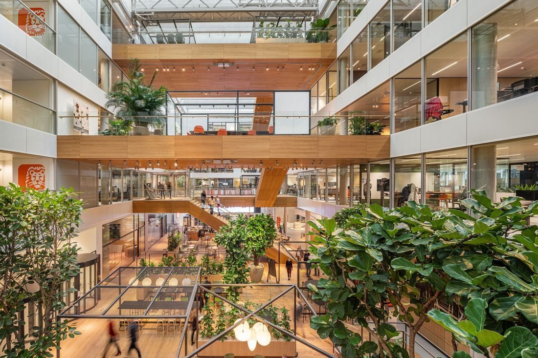 ING Group: View across a planted atrium with wooden walkways and glass office floors