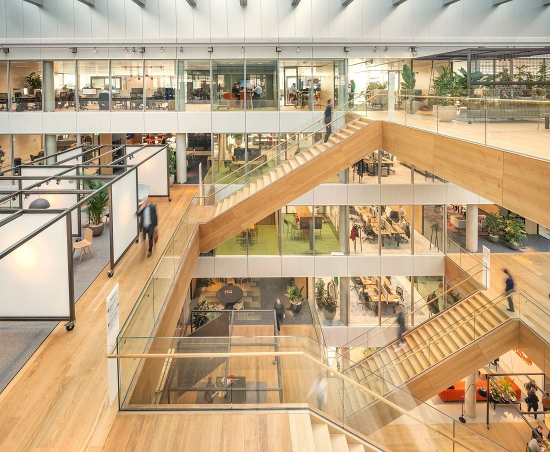 ING Group: Wooden staircase rising through an atrium past glass balustrades and office floors