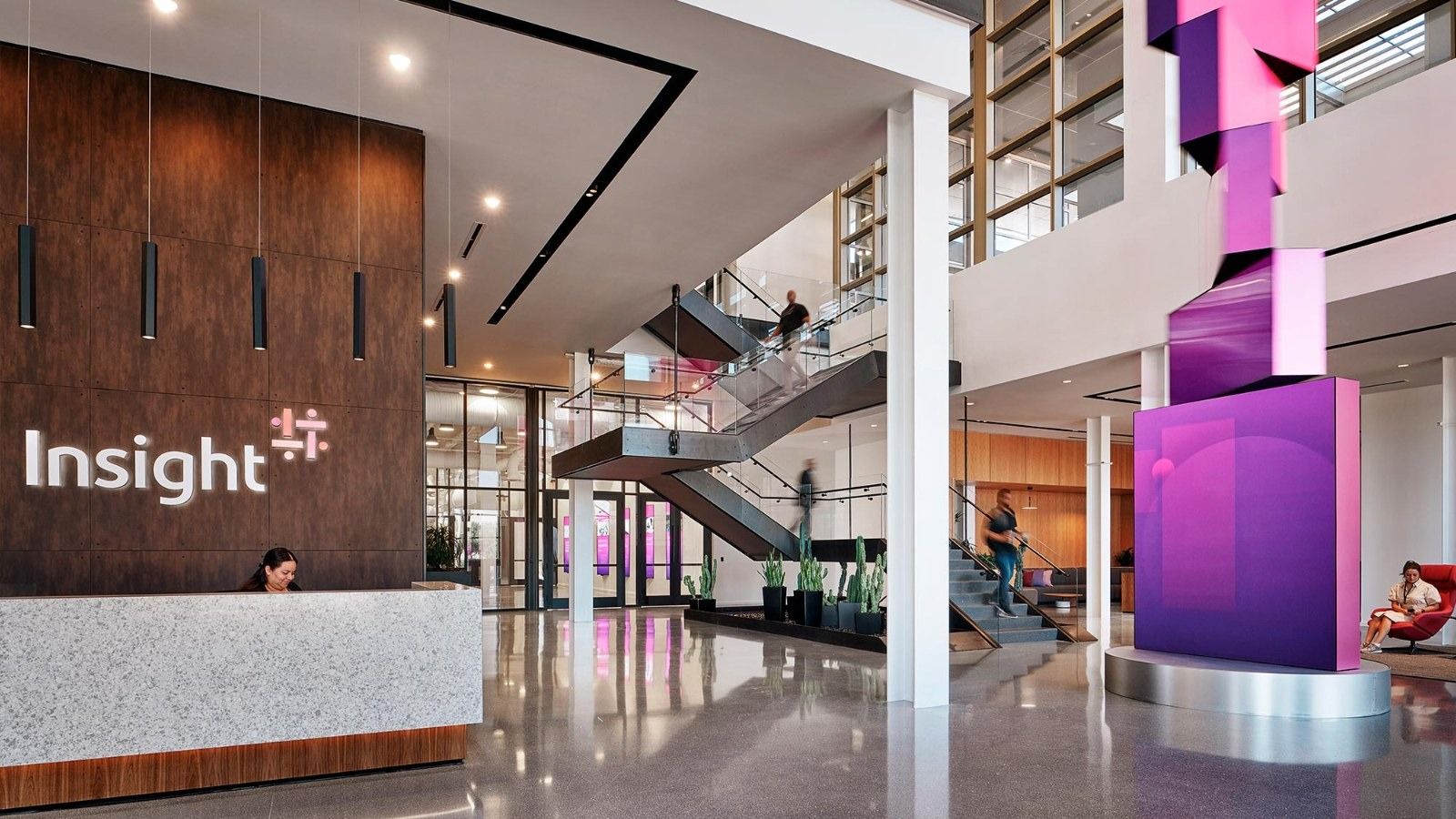 Insight Enterprises: A reception desk with the Insight logo beside a tall magenta sculpture