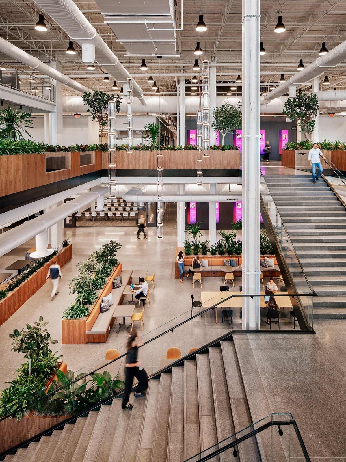Insight Enterprises: A stair rising through several levels with planters and tables