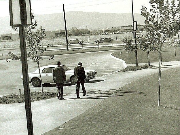 Two men walking to a parking lot beside Intel's new building in 1970