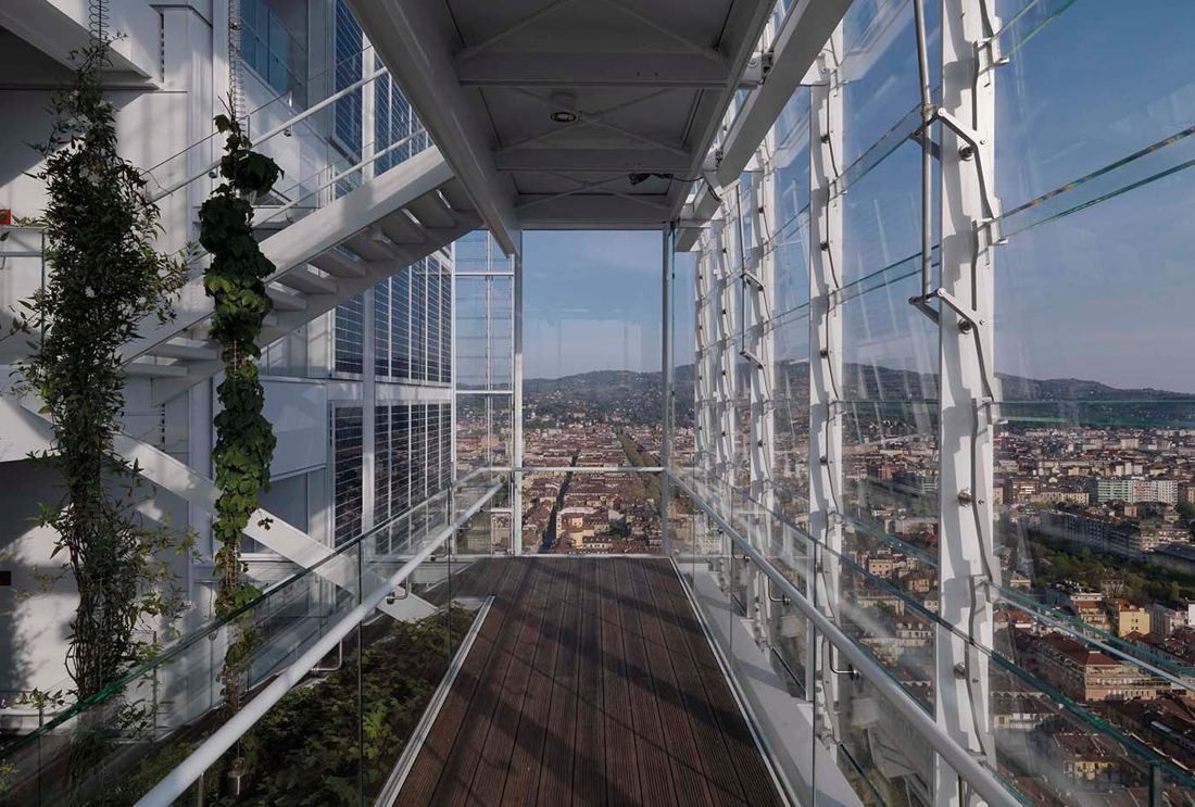Intesa Sanpaolo: A glazed walkway with climbing plants high in the tower, looking out over the city