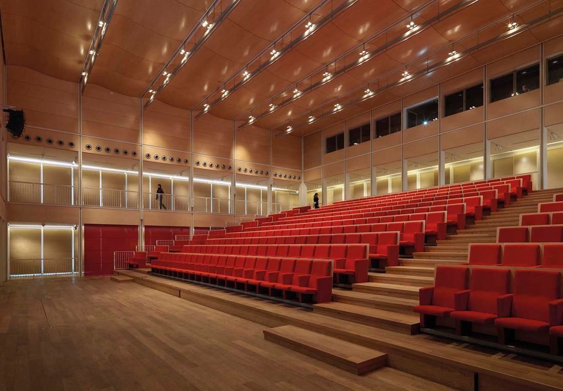 Intesa Sanpaolo: Auditorium with rows of red seats under a wooden ceiling