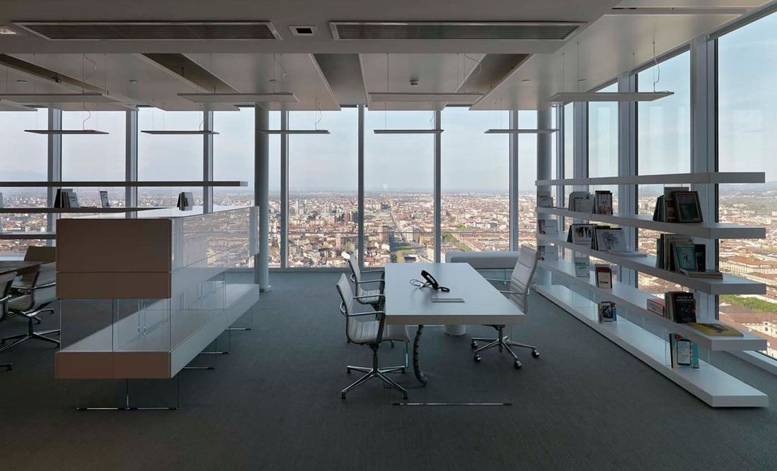 Intesa Sanpaolo: Office floor with a meeting table, white shelving and floor-to-ceiling windows over the city