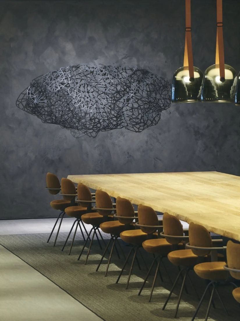 ITOKI: Long wooden table with orange chairs under pendant lights