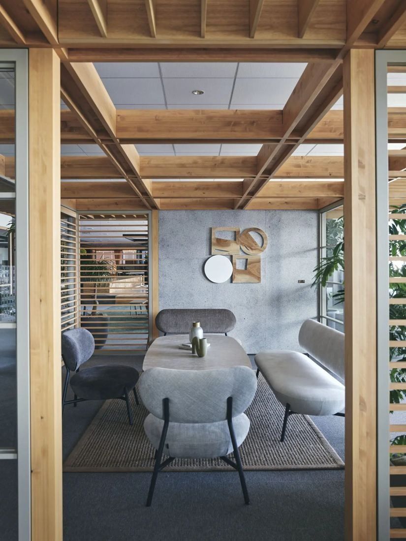 ITOKI: Lounge chairs and a table inside a timber-framed nook