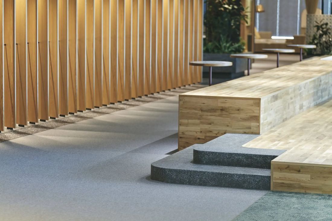 ITOKI: Stepped wooden platform in front of a wall of vertical timber fins
