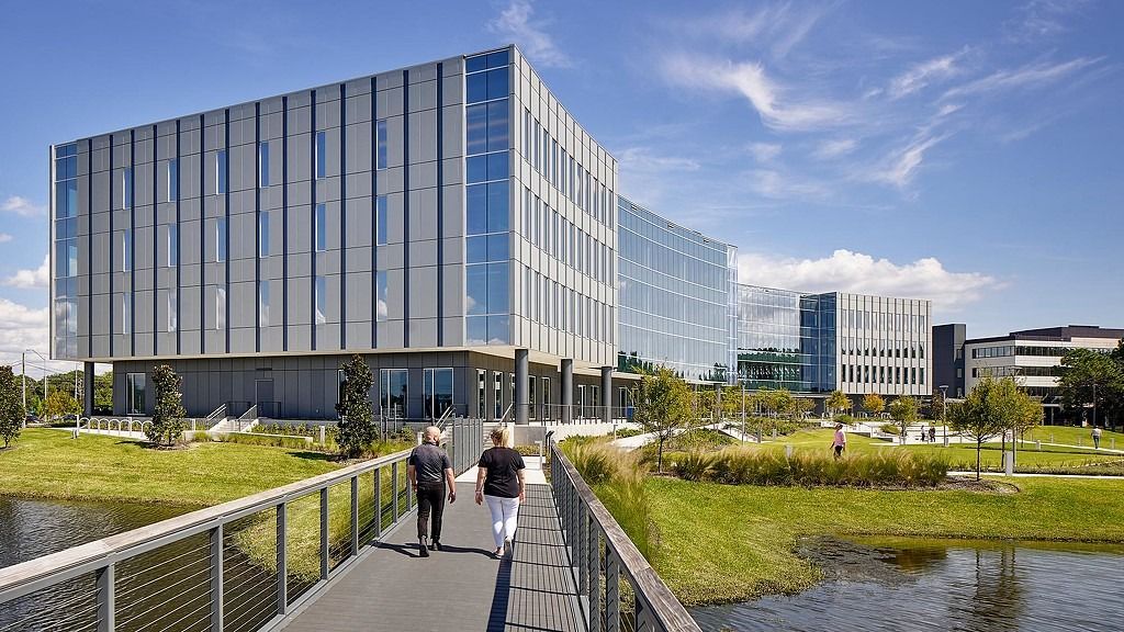 Jabil: A boardwalk leading across a wetland toward glass office buildings