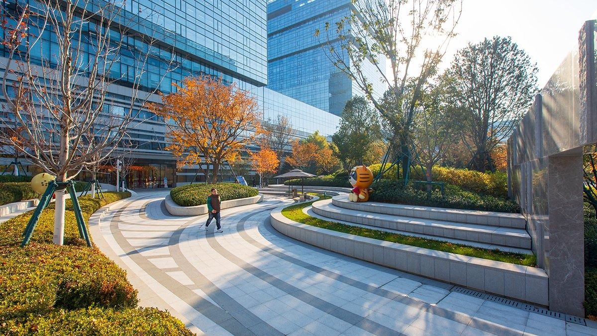 JD.com: Curving stone path and planted terraces between glass buildings