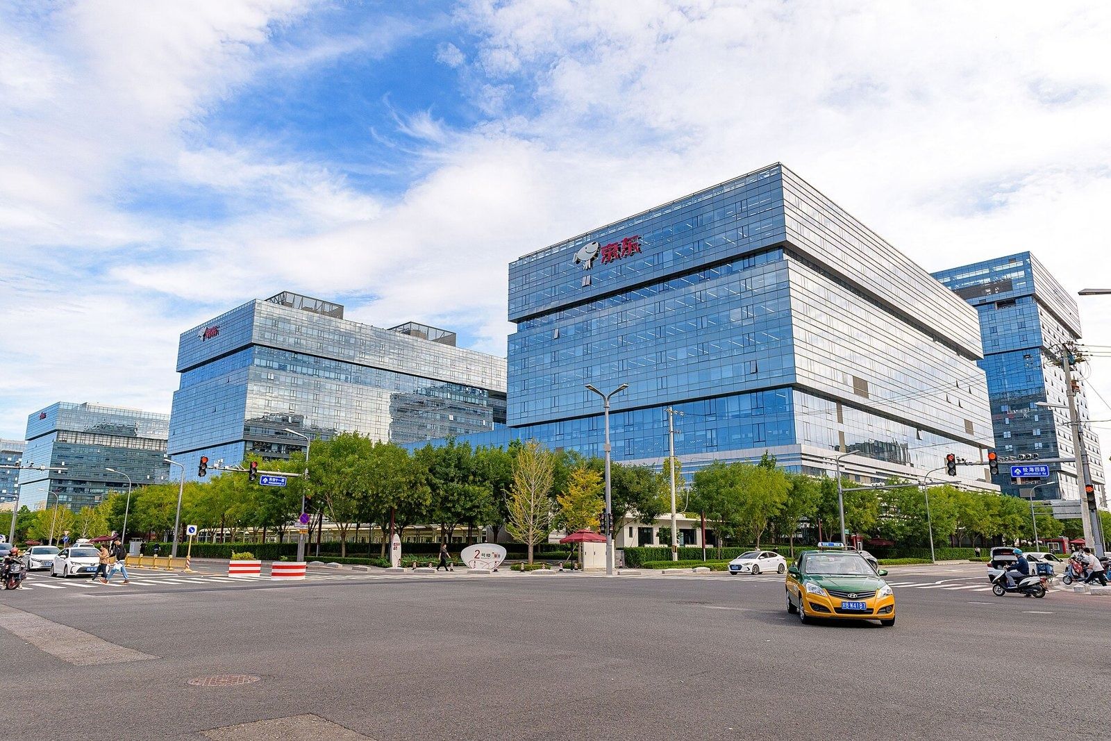 JD.com: Glass office building with stacked blocks beside a wide street