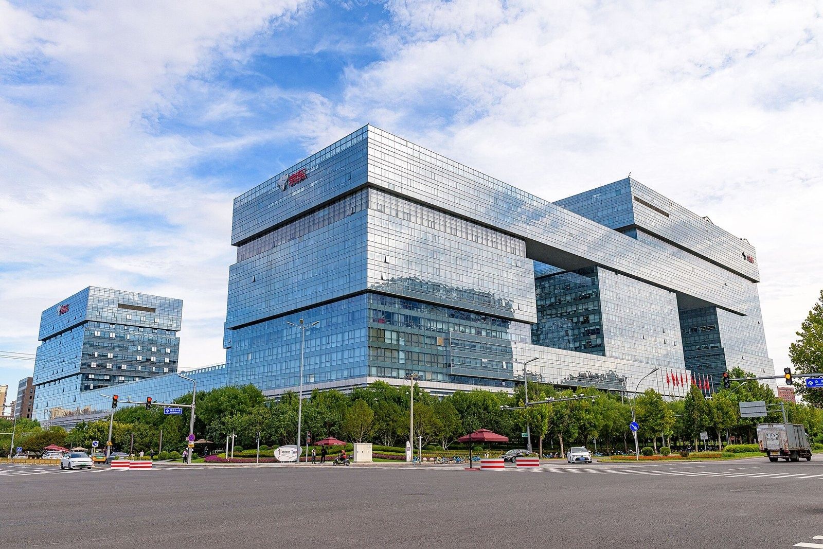 JD.com: Large glass headquarters building with stepped blocks and a red logo