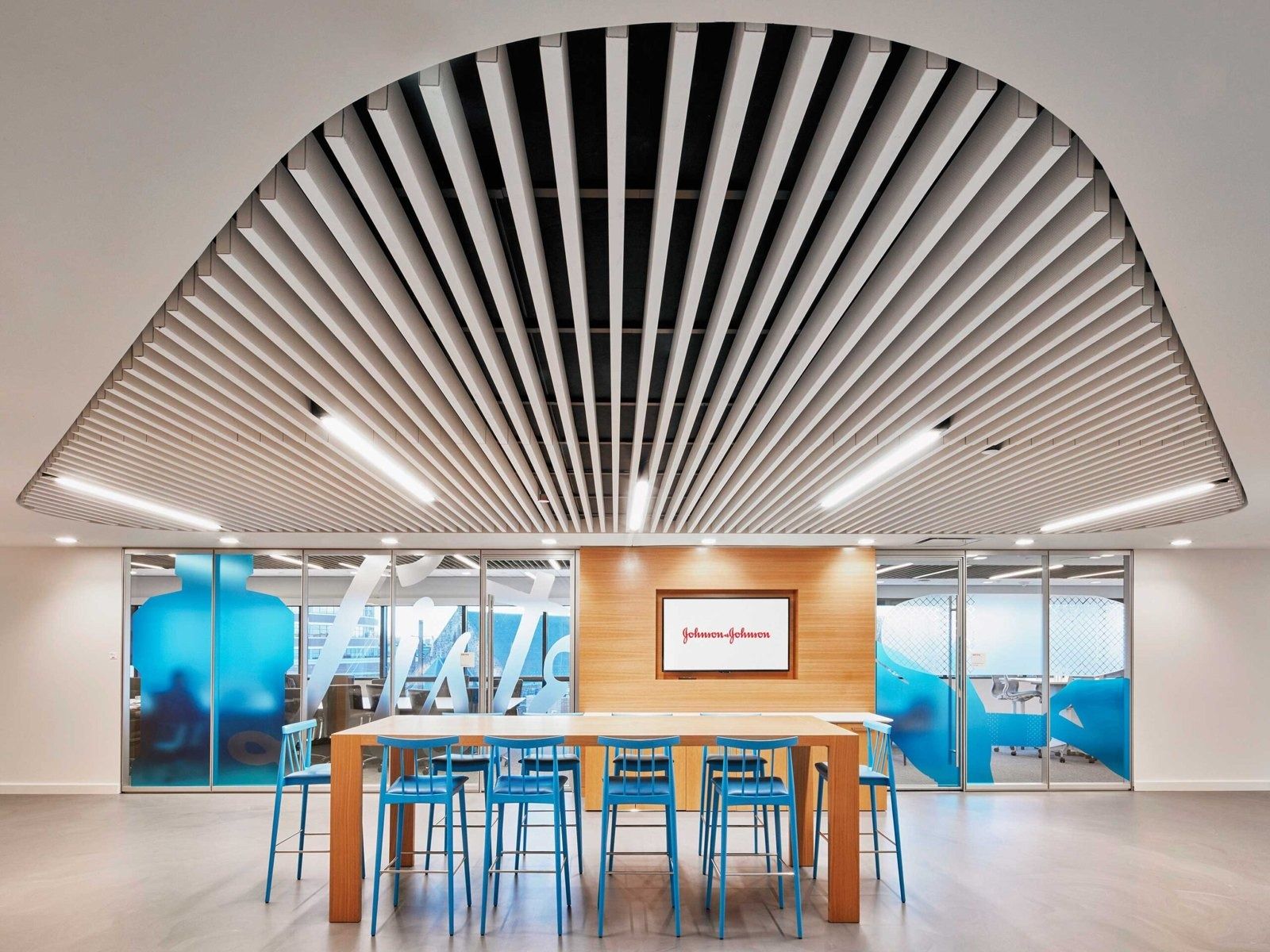 Johnson & Johnson: A long table under a curved slatted ceiling