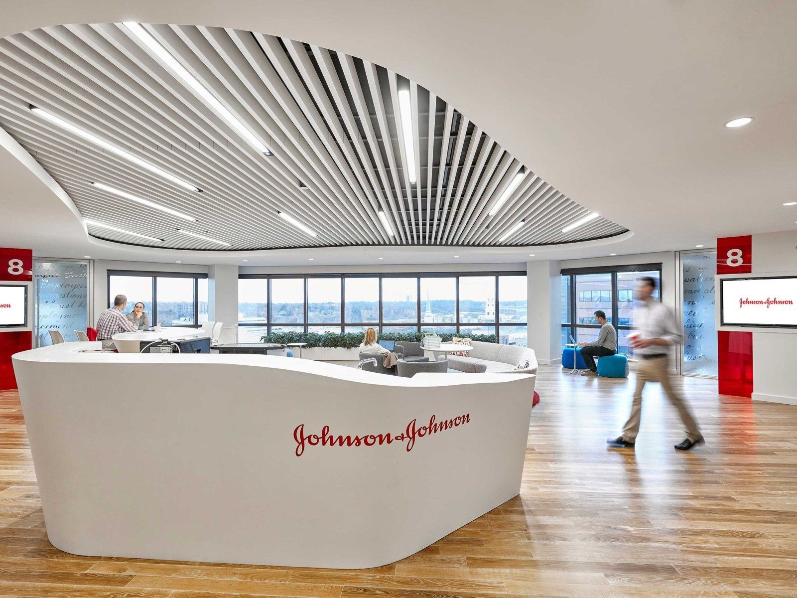 Johnson & Johnson: A white reception desk under a sweeping ceiling of slats