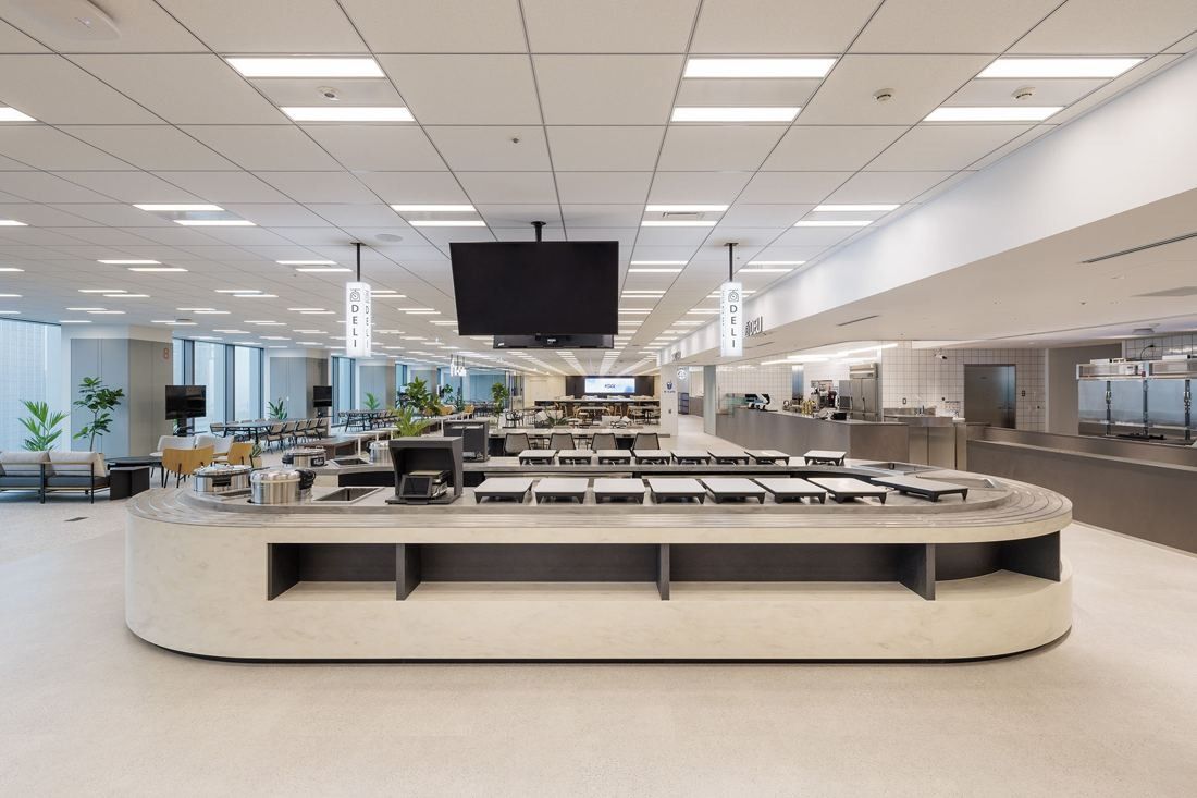 KDDI: A large white island counter in the middle of a bright, open dining space