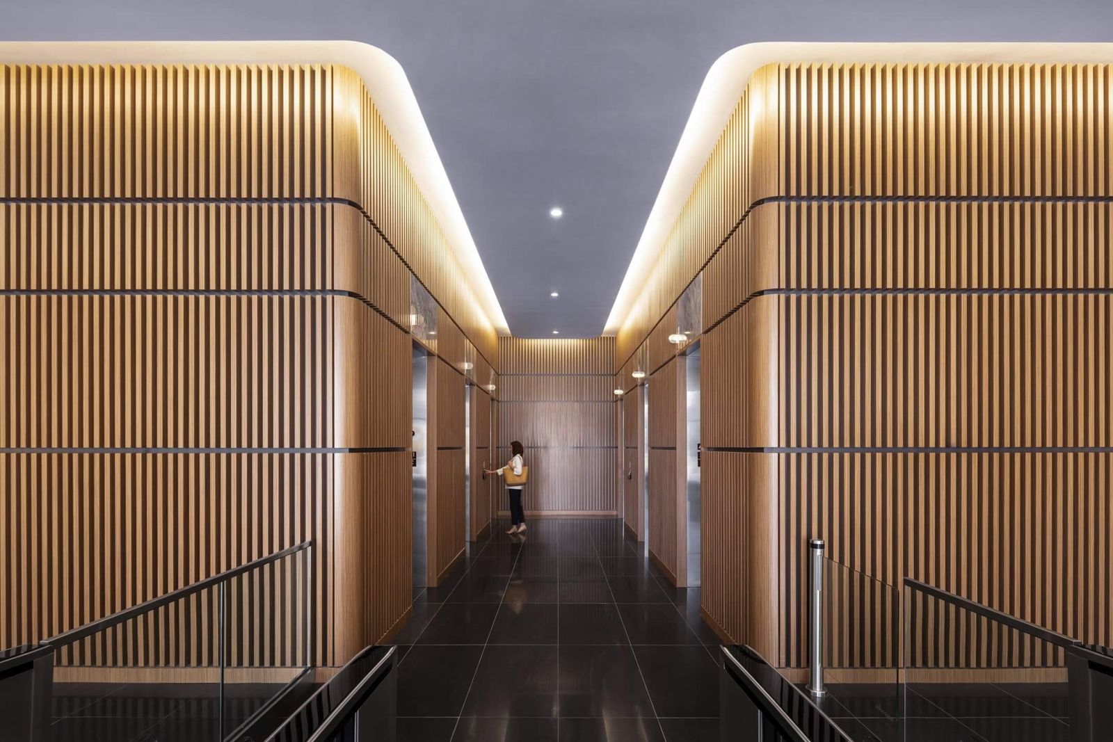 Keurig Dr Pepper: A long corridor between warm wood-slat walls with a lit ceiling