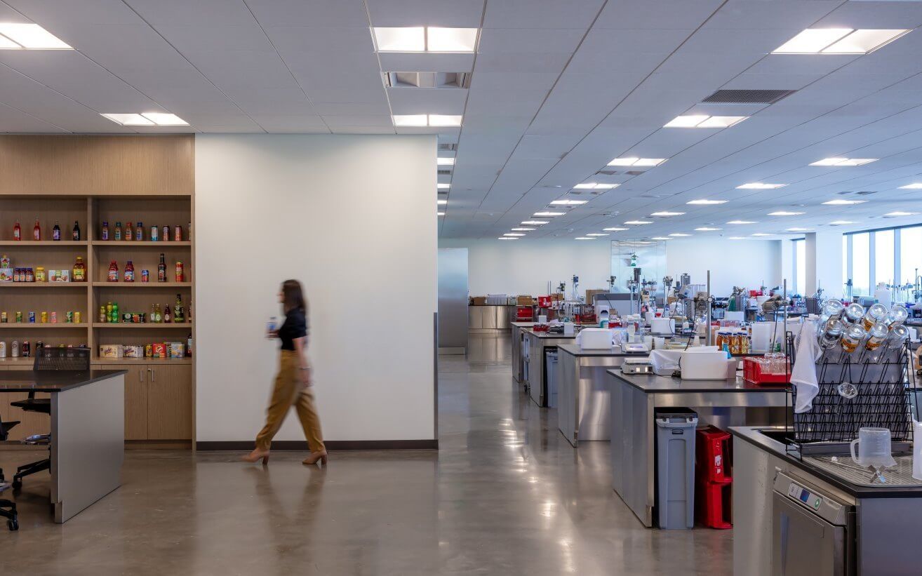 Keurig Dr Pepper: A long open lab with workbenches and shelves of drink products
