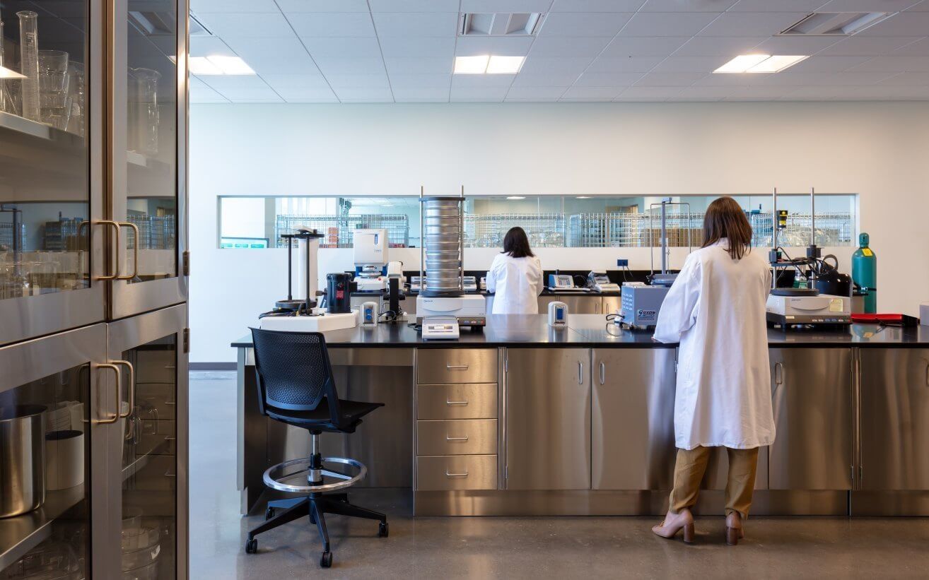 Keurig Dr Pepper: A scientist in a white coat at a stainless steel bench in a beverage lab