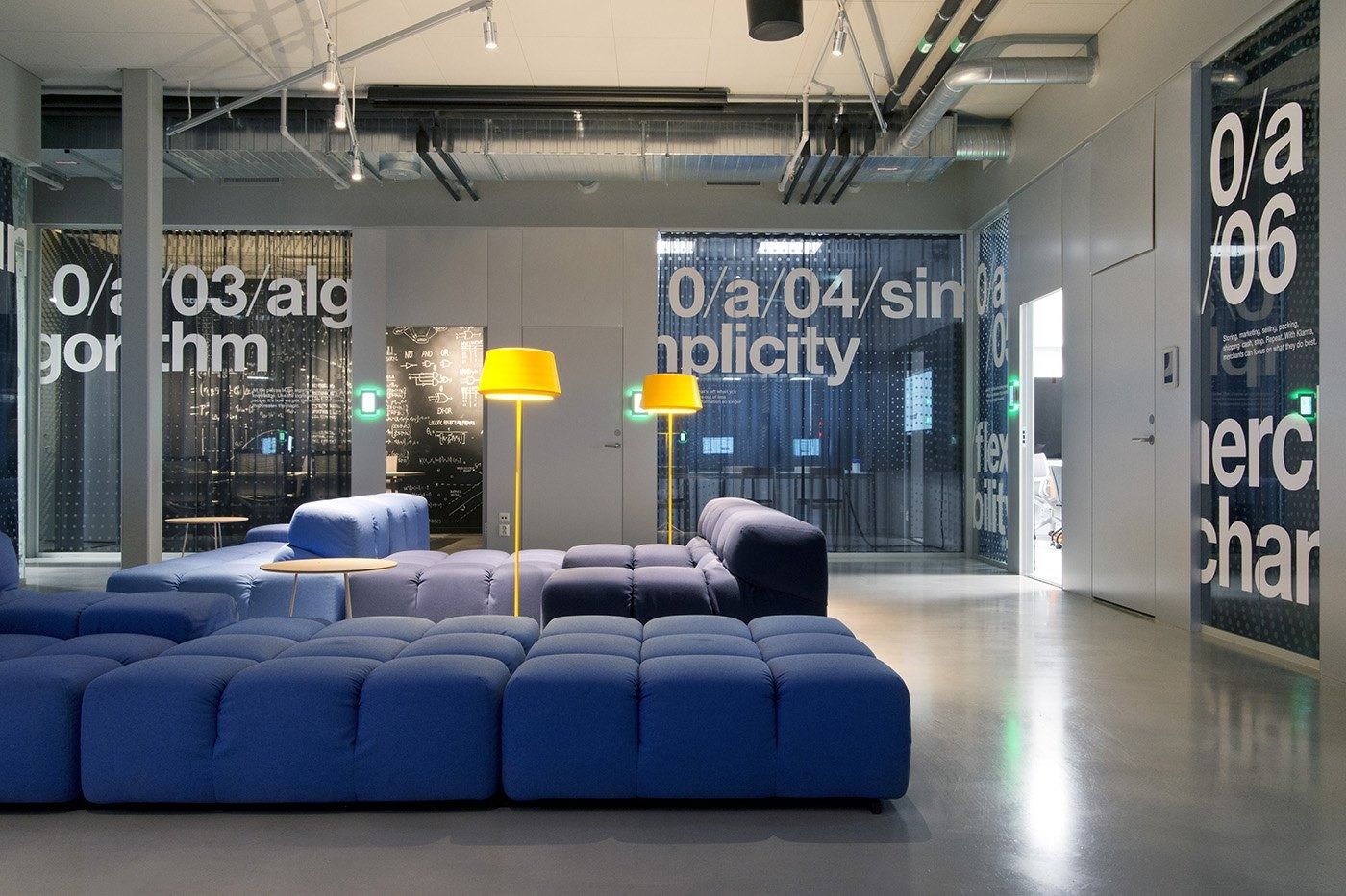Klarna: Blue sofas in front of glass meeting rooms with large printed lettering