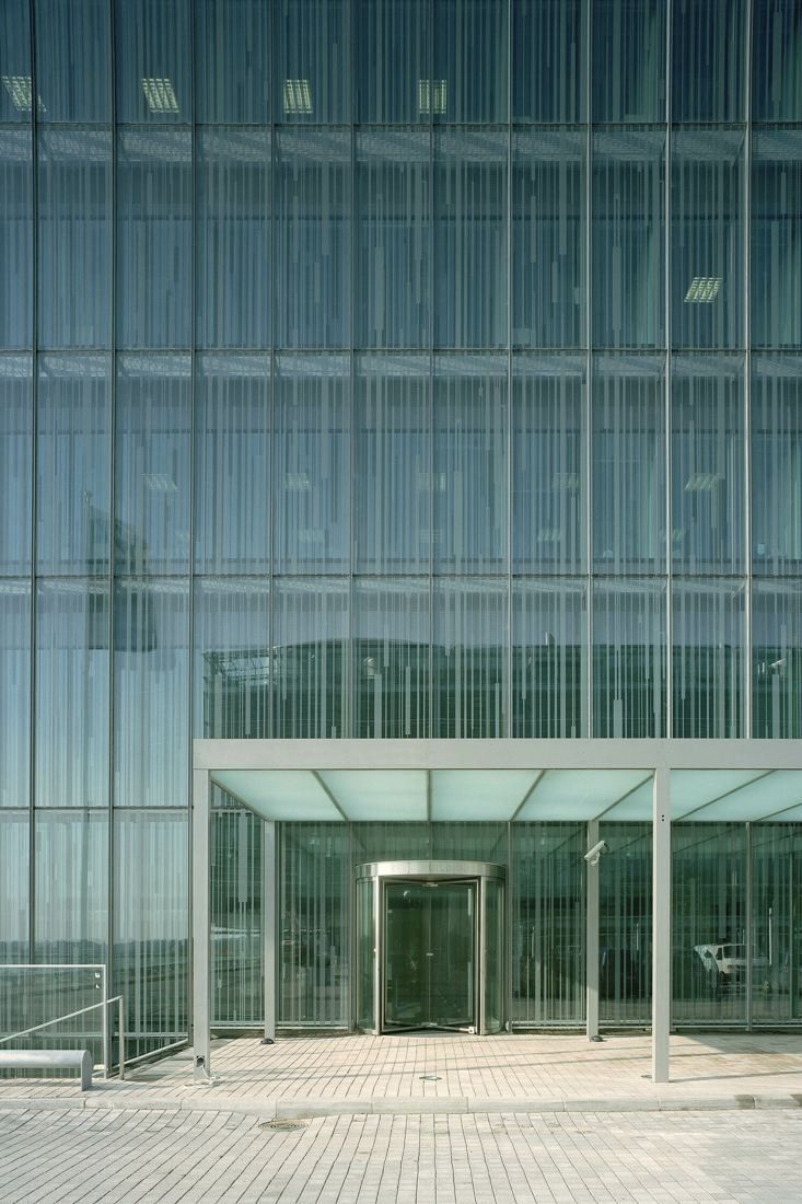 KONE: Glass entrance canopy and revolving door at the base of a fully glazed facade