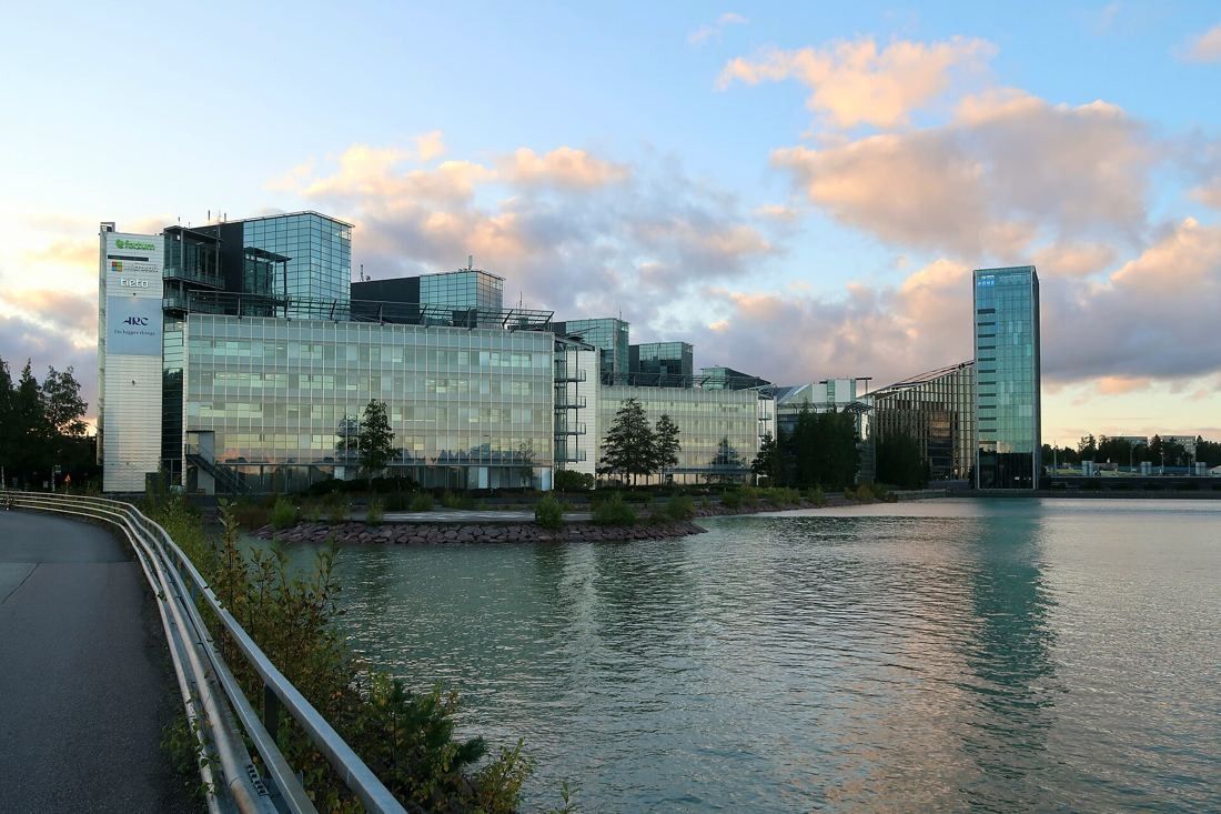 KONE: Glass office buildings along a bay with a slim tower at the right