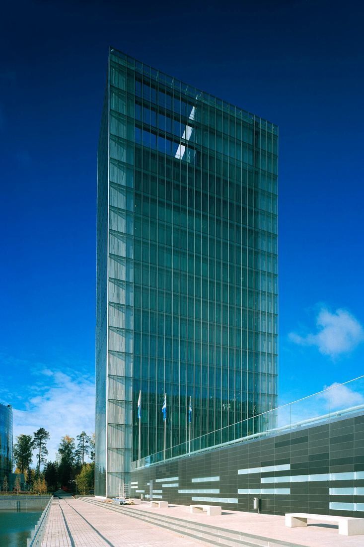 KONE: Glass tower seen from below against a deep blue sky