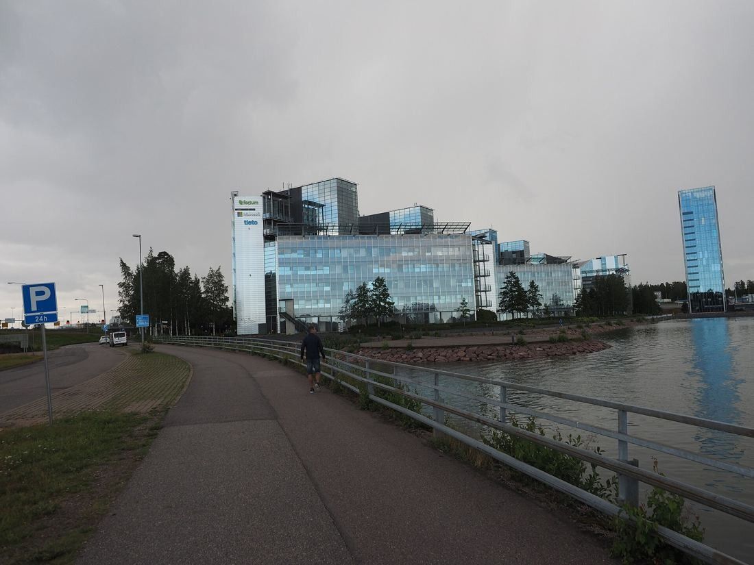 KONE: Shoreline path leading toward glass office buildings and a slim tower